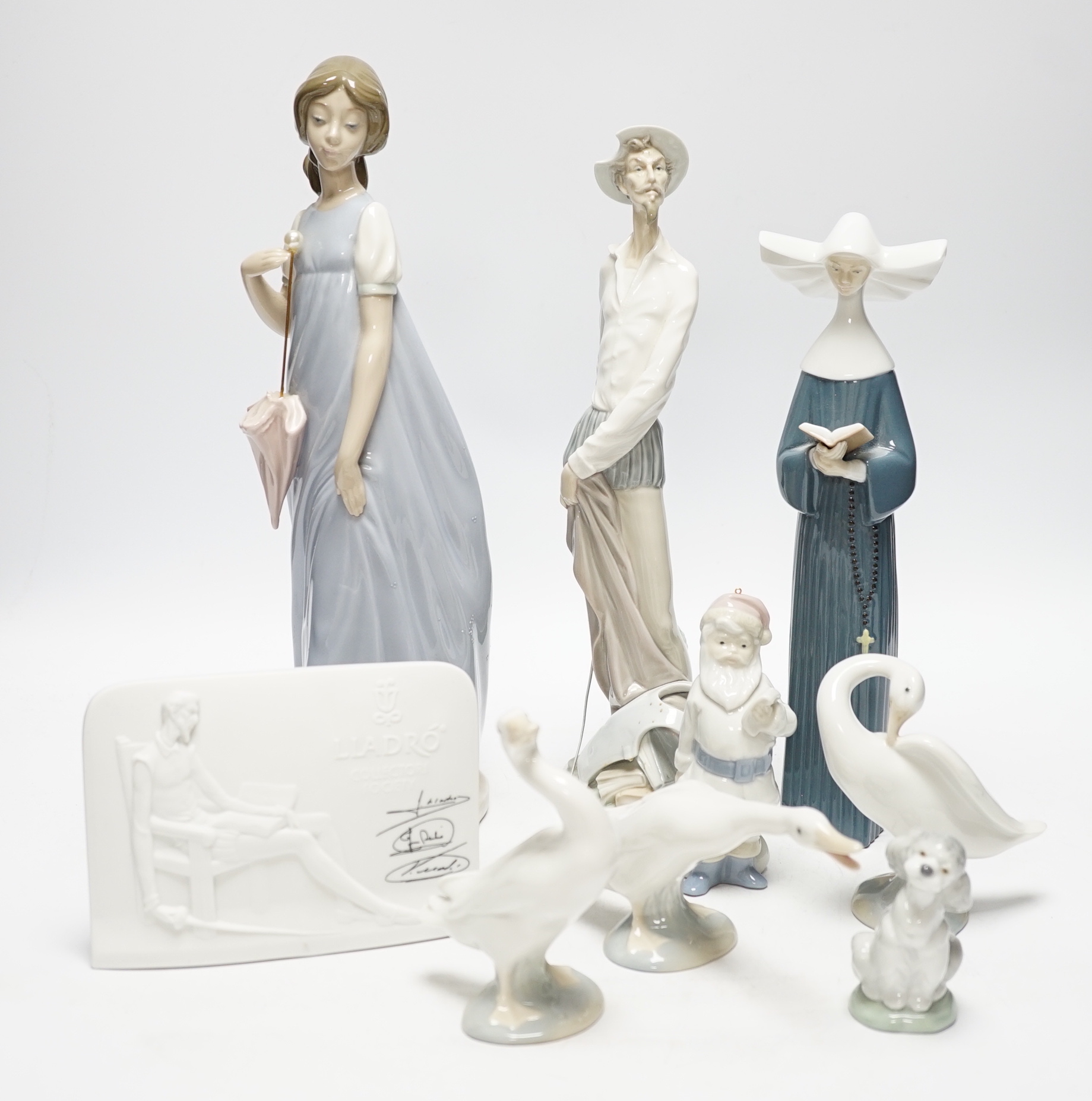 Twelve Lladro figures including a dog and three ducks, a plaque and two cups together ith three Nao figures, tallest figure 32cm high (original boxes included)